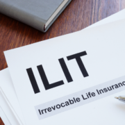 "ILIT: Irrevocable Life Insurance Trust" with a pen resting on top.